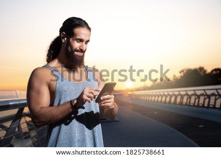 Morning running. Muscular young man during his workout on the street. Fit, fitness, workout, exercise, dips and healthy lifestyle concept.
