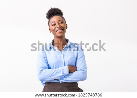 Young African American business woman with arms folded standing, looking at camera, smiling. Female business leader concept