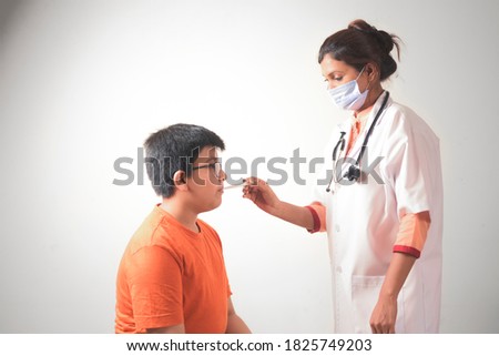lady doctor wearing mask checking temperature of child boy  patient