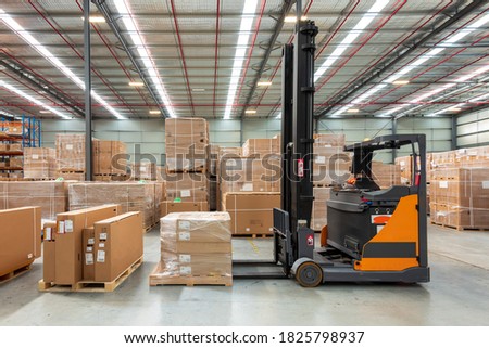 Forklift parked at logistics warehouse.