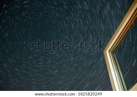 Northern hemisphere star trails through a window and following The Big Dipper constellation during the Covid-19 pandemic with little airplane activity remains. 12 August 2020