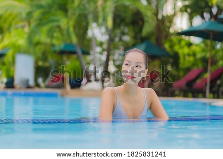 Portrait beautiful young asian woman enjoy relax smile leisure around outdoor swimming pool in hotel resort for holiday vacation