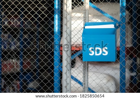 "Safety data sheet (SDS)" box which is use to placed chemical characteristic documents that locate in front of chemical storage room. Industrial object photo. 