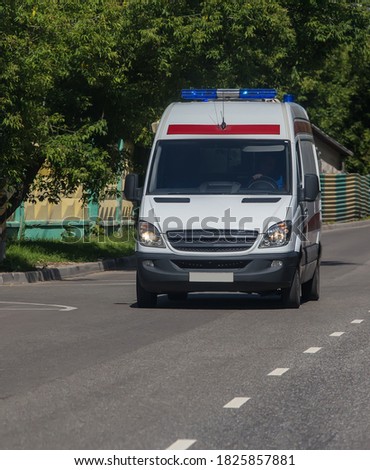 Ambulance car moves along the city street