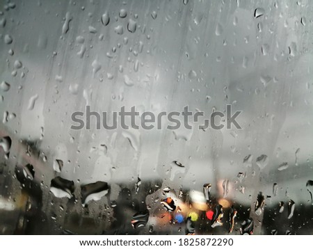 Rain drops on the car window during the rain.