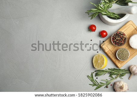 Flat lay composition with ingredients for cooking on grey table. Space for text Royalty-Free Stock Photo #1825902086
