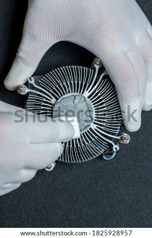 Cpu cooler with old thermal paste. Servicing pc and cleaning old paste. Royalty-Free Stock Photo #1825928957