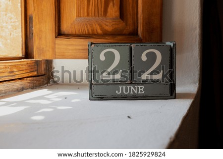 wooden blocks calendar showing the 22 of june