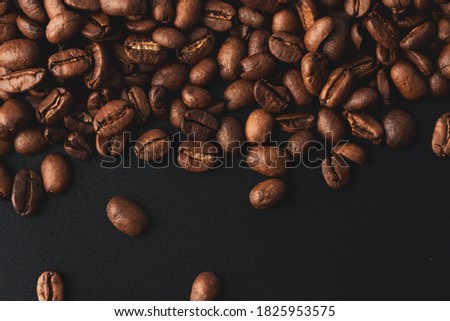 Close-up studio shot of freshly roasted espresso coffee beans. Macro photography, top view.  Royalty-Free Stock Photo #1825953575