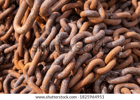 Rusty chains in a pile in the harbor of Zoutkamp in the province of Groningen, The Netherlands