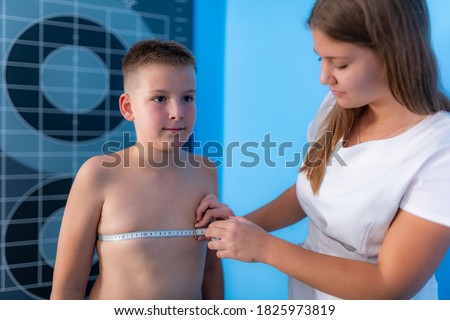 Body fat analysis of children, anthropometric chest circumference tape measurement Royalty-Free Stock Photo #1825973819