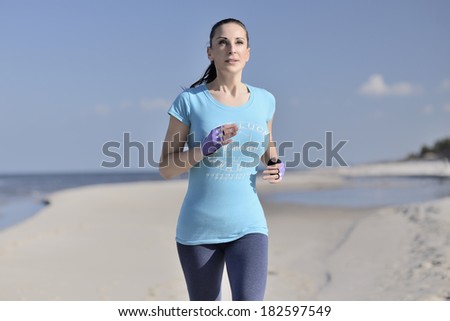 picture of a young woman has the joy of making sport on the beach