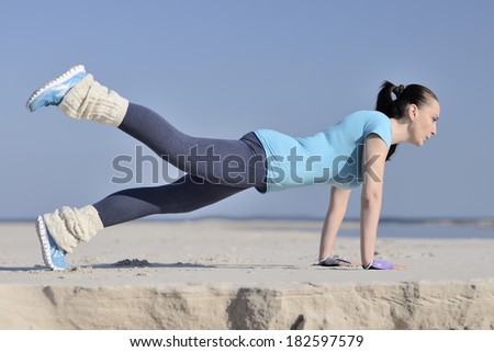 picture of a young woman has the joy of making sport on the beach