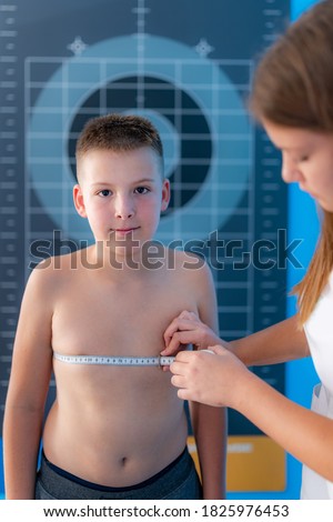 Body fat analysis of children, anthropometric chest circumference tape measurement Royalty-Free Stock Photo #1825976453