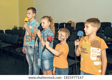 Children participate with a microphone, recite poems, recitation, sing songs.