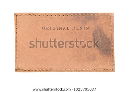 Leather clothing label says original denim isolated over white
