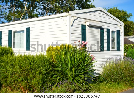 Mobile home on a camping site with small garden Royalty-Free Stock Photo #1825986749