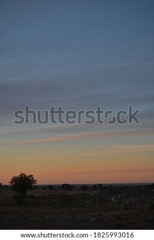 A dusky sky fading from grey to orange Royalty-Free Stock Photo #1825993016