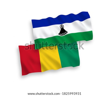 National vector fabric wave flags of Lesotho and Guinea isolated on white background. 1 to 2 proportion.