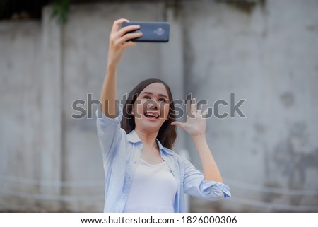 Beautiful asian woman take selfie by smartphone.