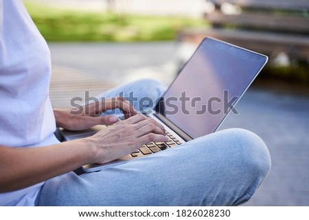 Close up photo of girl using computer with pleasure. Hands on the keyboard, typing, Internet browsing