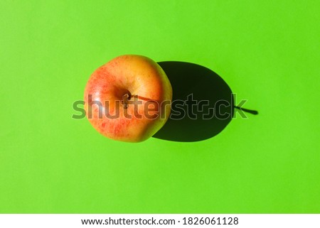 an Apple with a hard shadow on a plain background. the view from the top. blank for the pattern