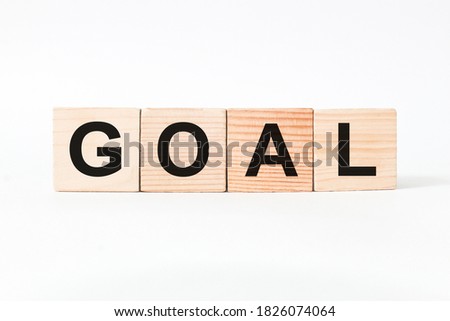words GOAL on wooden cubes, white background. business concept