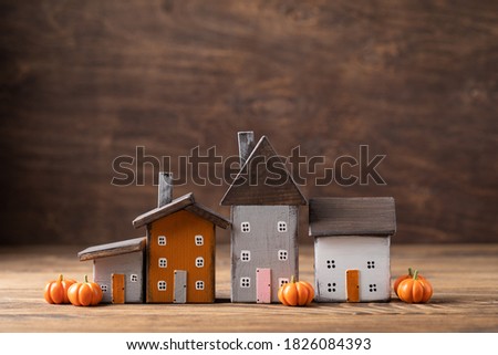 Miniature Thanksgiving Day little cosy fairy tale autumn cottages, pumpkins, wooden background, postcard concept, toned