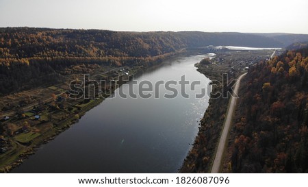 Top view of the river in the autumn forest. Multicolored autumn concept. Autumn in Russia.