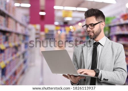 Wholesale and logistics concept. Manager using laptop in store