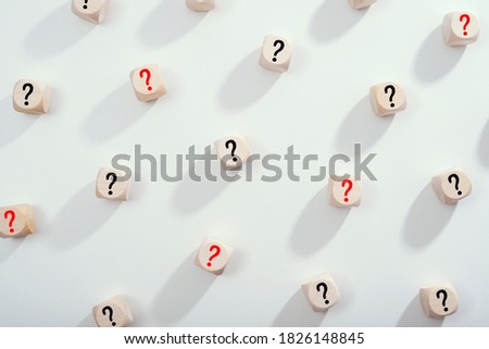 Wooden cubes with questionmarks on bright background