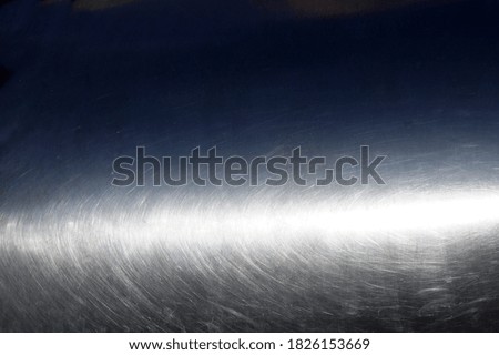 Surface of bent shiny metal. In the rays of the sun. Close-up. Background.