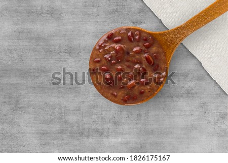 A spoon with Brazilian Feijoada Food. Top view. wooden table background.
