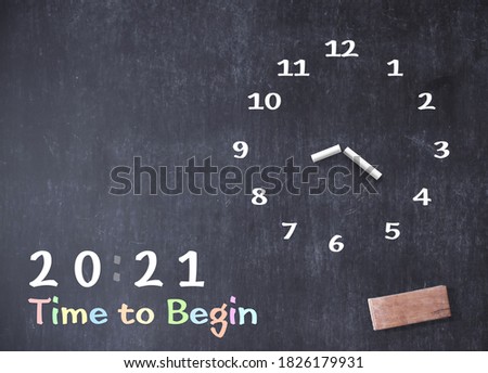 Concept for 2021 time to begin: Hand-drawing clock with text on grungy blackboard