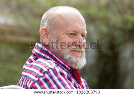 Picture of disabled elderly man's  sitting in a wheel chair outdoors
