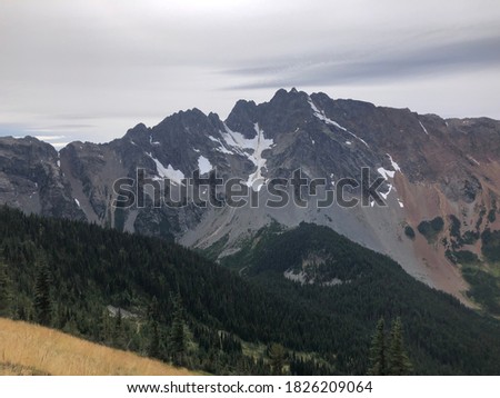 Pictures from the Pacific Crest Trail (PCT) in the Northern Cascades on approach to the Northern Terminus, or finish line. Trails, mountains, cloudy weather and sunshine. Scenic landscapes.
