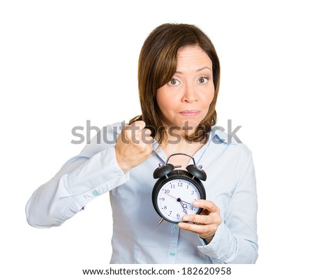 Closeup portrait of angry, demanding boss, woman, funny looking girl, holding alarm clock, requesting employees to be on time pushing for project deadline isolated white background. Negative emotion