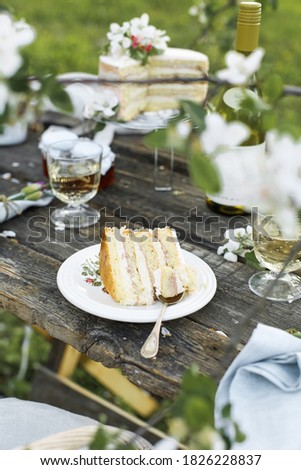 Rustic wedding cake with white lilac, light background, close up, selective focus