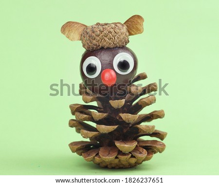 
funny owl from pine cone and acorn hat tinker with children in autumn Royalty-Free Stock Photo #1826237651