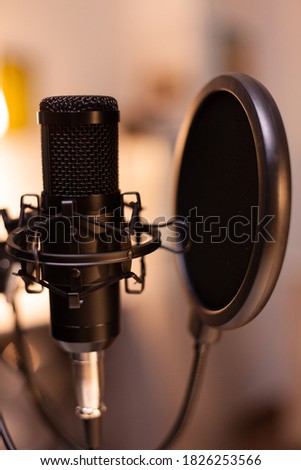 Microphone for podcast of famous influencer in home studio ready for recording. Logging social media content with production microphone. Digital web internet streaming station
