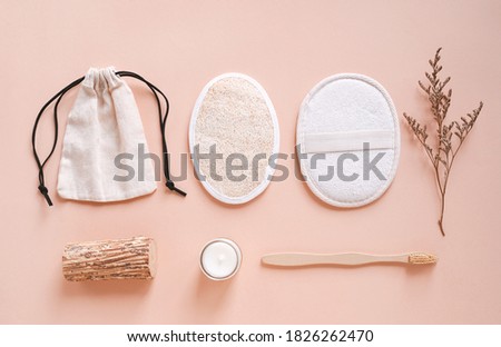 Flat lay of sustainable products, bamboo toothbrush and organic scrub pad on autumn color background, eco friendly and zero waste concept