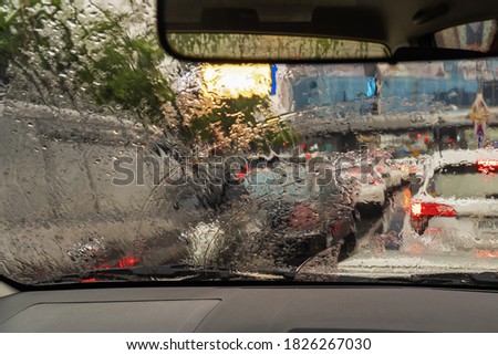 Traffic jam during the rain in the metropolis. Blurred background