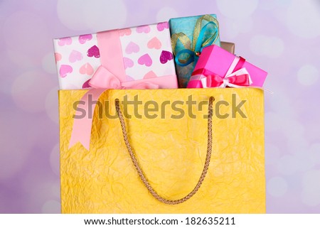 Presents in paper bag on bright background