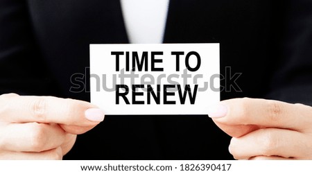 The businessman puts a card in his pocket with the inscription TIME TO RENEW.