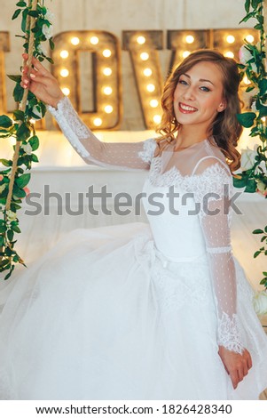 Wedding day and beautiful bride in studio. Beautiful young bride with wedding makeup and hairstyle. Portrait of young gorgeous bride. Wedding. Royalty-Free Stock Photo #1826428340