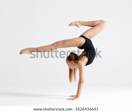 Young gymnast girl stretching and training