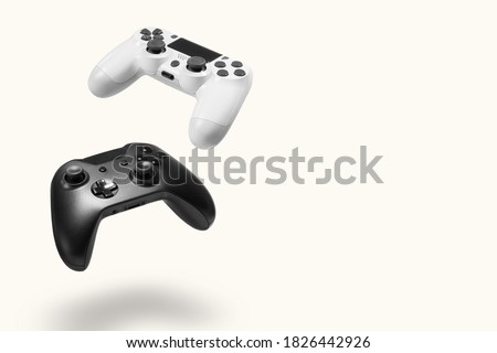 White and black game controllers on white background