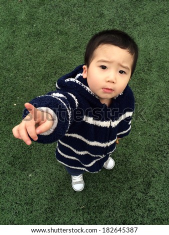 Cute Asian baby playing in the stadium