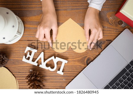 A top view of gift box with Christmas decorations over wooden table, holiday and background concept
