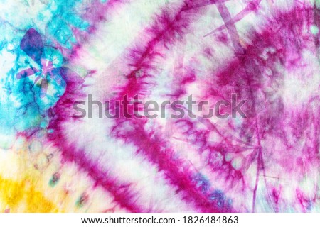 textile background - detail of colorful colored batik silk scarf with hand-drawn bamboo twig and butterfly